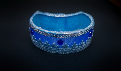 Obraz premium Purchased blue candlestick close-up on a black background