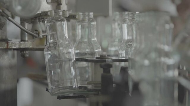 Bottles for compotes on the production line. Slow Motion 100 fps 