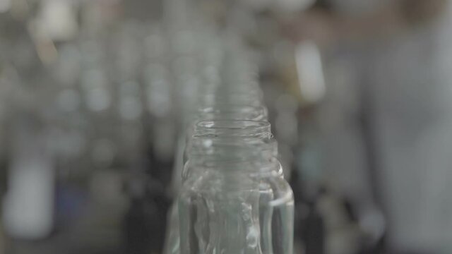 Bottles for compotes on the production line. Slow Motion 100 fps 