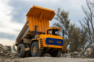 Large mining dump truck. Transport industry. Extraction of stone in an open pit