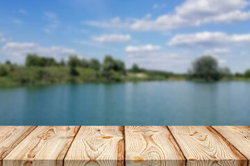 Wooden board empty table in front of blurred background. Perspective brown wood over the blur of summer beach landscape background. Mock up for display of product.