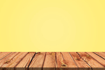 Naklejka na ściany i meble Wooden board empty table in front of yellow wall background. Mock up for display of product.