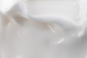 Close-up cream moisturiser smear smudge wavy texture on white background. Skin care beauty product