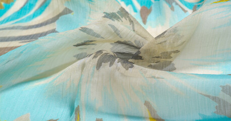 texture background pattern. Silk fabric with colored lace. Yellow blue and gray-blue shades. It is...