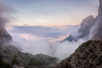 sunrise in the cloudy mountains of dolomites in pale di san martino