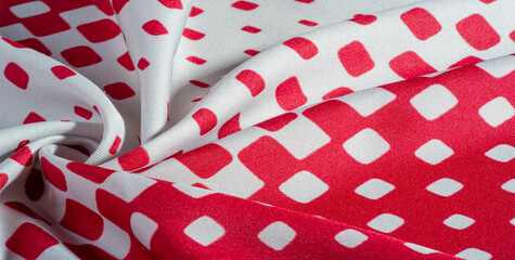 texture background pattern. silk fabric with a pattern of red squares on a white background. This...