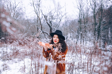 Fototapeta na wymiar Winter portrait of a young woman wearing warm winter coat and scarf. 