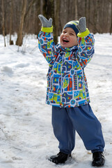 Smiling boy on the background of a snowy forest