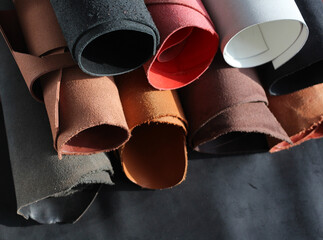 Close-up pieces of the leather material on the working desk in the leather workshop.