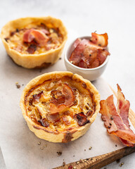 Mini pies with onion and bacon. Hearty pastries