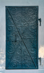 Black metal door with round celtic ornaments, medieval iron door
