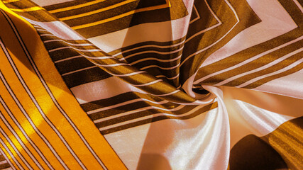 Texture, background, silk fabric with a yellow striped pattern. The design of this fabric is...