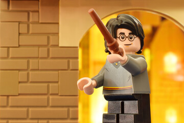 Obraz premium Lego minifigures Harry Potter with magic wand clossed up. Editorial illustrative image of literatur fairy tail scene.