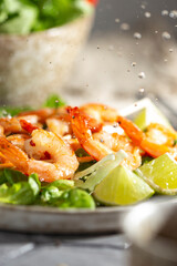 Grille shrimps with salad on a plate