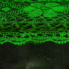 Texture, background, pattern. Emerald green lace fabric, a combination of green with black fabric. verdant, lawny, virid, vealy
