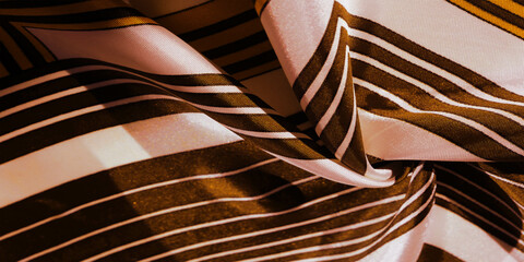Texture, background, silk fabric with a yellow striped pattern. The design of this fabric is...