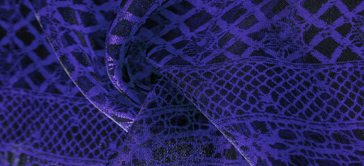Texture, background, pattern. Sapphire blue lace fabric, a combination of blue with black fabric....