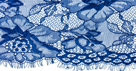 Blue lace fabric on a white background. Fancy African tulle lace fabric polyester with full length flowers for your design. The texture. Background. Pattern