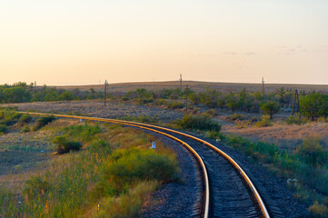 railway, railroad, rail, elevated. steppe prairie veld. is a means of transportation and passengers of trucks moving on rails that are located on the rails of the Great Plains. Kazakhstan  