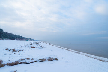 Empty winter snowy beach off season on Baltic sea