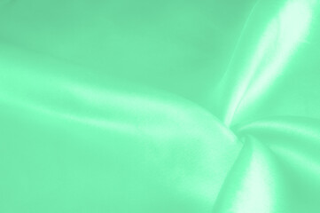 Green pale silk fabric, smooth elegant red silk or luxurious satin fabric, texture as wedding...