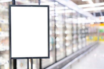 Blank poster frame template in supermarket. Blurred background