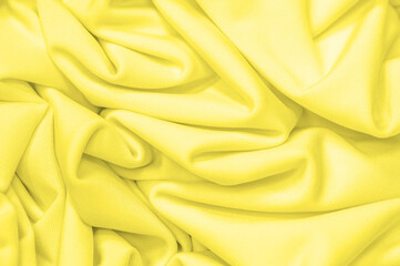 The fabric is yellow silk. Texture. Background. Pattern. Silk fabric has a shiny sheen and...