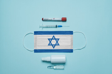 Blood tube for test detection of virus Covid-19 Omicron Variant with positive result, medicine mask with Israel flag superimposed and vaccine.  New Variant of the Covid-19 Omicron