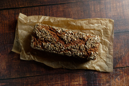 Box bread made of spelt whole grain on a wooden table. View from above with copy room.