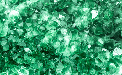 Green crystal mineral stone. Gems. Mineral crystals in the natural environment. Texture of precious and semiprecious stones. Seamless background with copy space colored shiny surface of precious stone