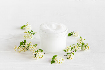 White organic cosmetic product with white flowers