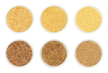 Golden and brown flax seeds, in white bowls. Whole, crushed and ground common flax or linseed, Linum usitatissimum, rich in omega-3 fatty acids, used as a nutritional supplement, or for linseed oil.