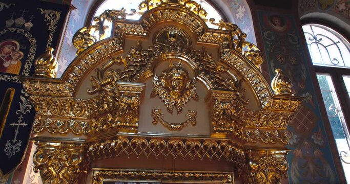 KYIV, UKRAINE � OCTOBER, 02, 2021 Kiev Pechersk Lavra,  interior view incide  Christian Orthodox church. Golden frame and icon with saints. Tracking shot, detail close up