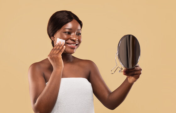 Smiling Black Woman Using Matt Control Blotting Papers And Looking In Mirror