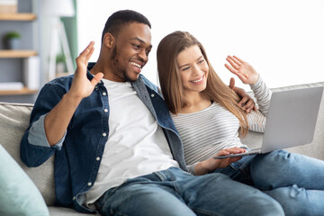 Video Call. Cheerful Young Multicultural Couple Having Web Conference On Laptop