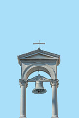 Cover page with ancient monastery simple bell tower with a cross at blue sky solid background with copy space. Concept of religious and historic heritage.