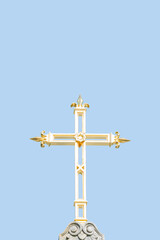 Ancient monastery golden cross at blue sky solid background with copy space. Concept of religious and historic heritage.