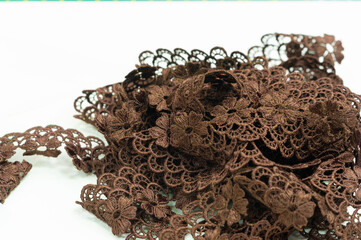 Brown lace ribbon. This ribbon is used in crafts and design, decorating your projects, gift wrapping, textiles, and the kids' fashion industry.