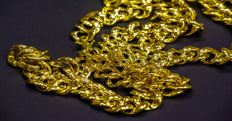 Gold chain to be worn around the neck. A chain is a sequential assembly of connected parts, made of...