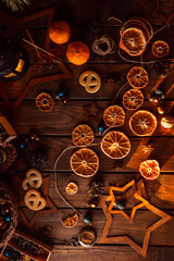 Dried slices of oranges cut into circles lie on a wooden table. New Year's Flatley