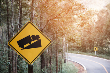 Traffic sign, beware of trucks on a curved road