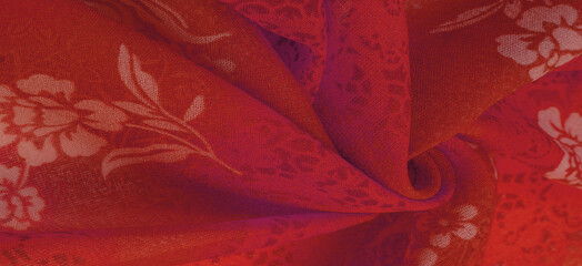 Texture, background, design. Red silk fabric with floral print.