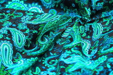 Paisley green pattern on black background In Chinese it is known as “ham pattern” In Russia this pattern is known as “cucumbers”. Boteh is a Persian word meaning bush, bunch of leaves or flower bud