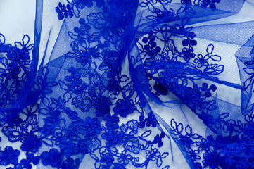 Colored blue lace fabric. Vintage. Flowers background in Provence style. Decorative ornament background for fabric, textile, wrapping paper, cards, invitations, wallpaper, web design.