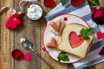 Breakfast for valentine's day or mother's day. Toast with salmon and cheese with the inscription that I love you, on a rustic table.  ​Top view flat lay. Copy space.
