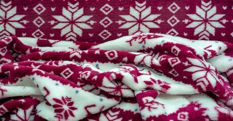 Fototapeta na wymiar Velvet. Plush. Winter clothes. Snow deer, snowflakes. Red and white tones. Thick silk fabric with a soft, smooth and thick pile..