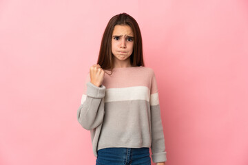 Little girl isolated on pink background with unhappy expression