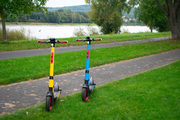 Obraz na płótnie Canvas Electric Scooters on Trail in Green City Park – Bonn Germany. European Energy Transition Motif