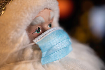 Toy Santa Claus With Face mask on face. An image with a shallow depth of field.