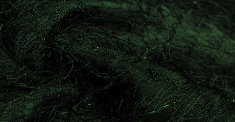 Emerald green silk fabric with sequins and yarns on the surface of the fabric. This abstract...